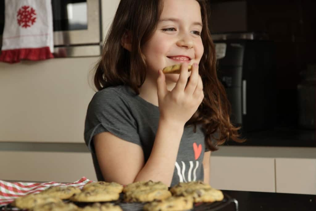 Girl smiling with Chocolate Chip Cookie