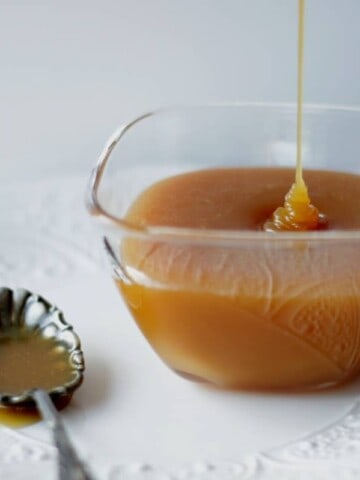 caramel sauce drizzling into small glass bowl