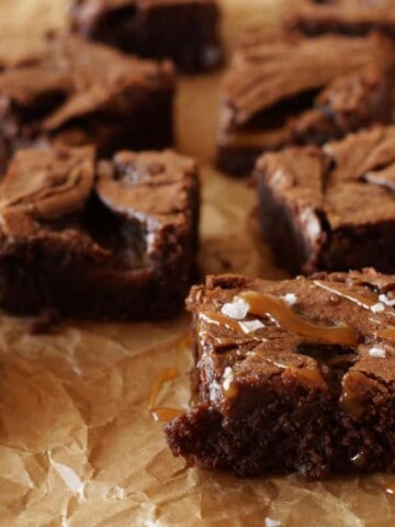 Salted Caramel Brownies on brown parchment paper