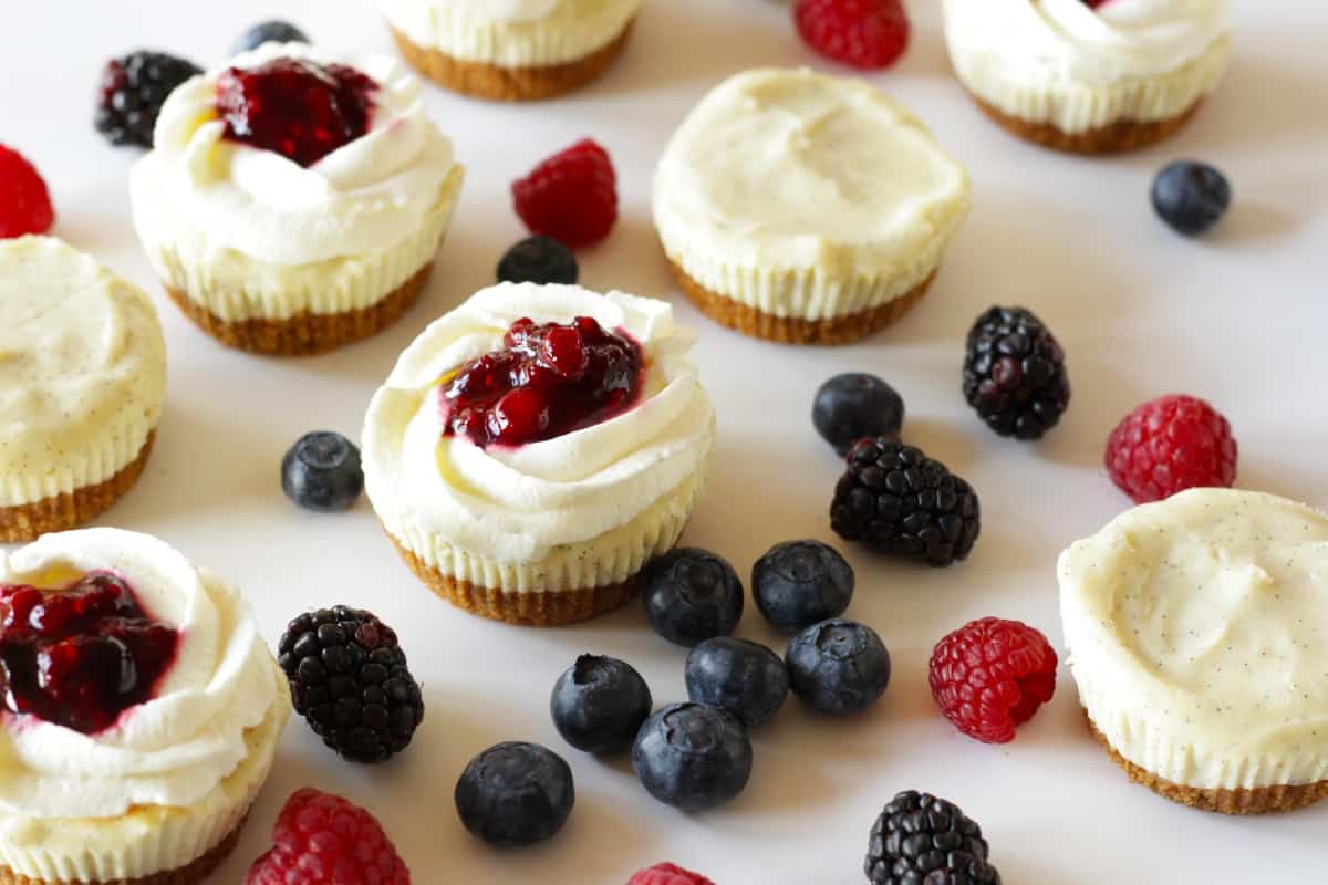 Cheesecake Cupcakes with Berries &amp; Cream - Living on Cookies