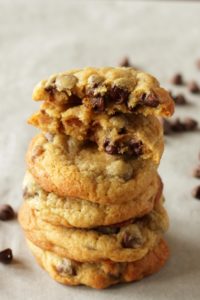 stack of chocolate chip cookies with top cookie broken in half