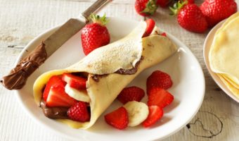 crêpes filled with nutella, strawberries and banana on plate