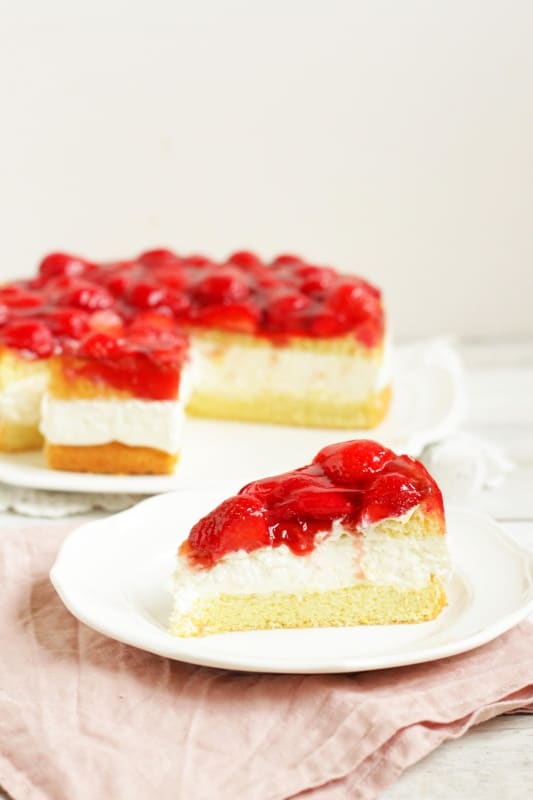 This beautiful torte consists of a fluffy, no-fail sponge cake, a divine topfen cream filling and glazed fresh strawberries. Topfen Torte with Strawberries is an elegant, classic Austrian cake. This is a must-try recipe!