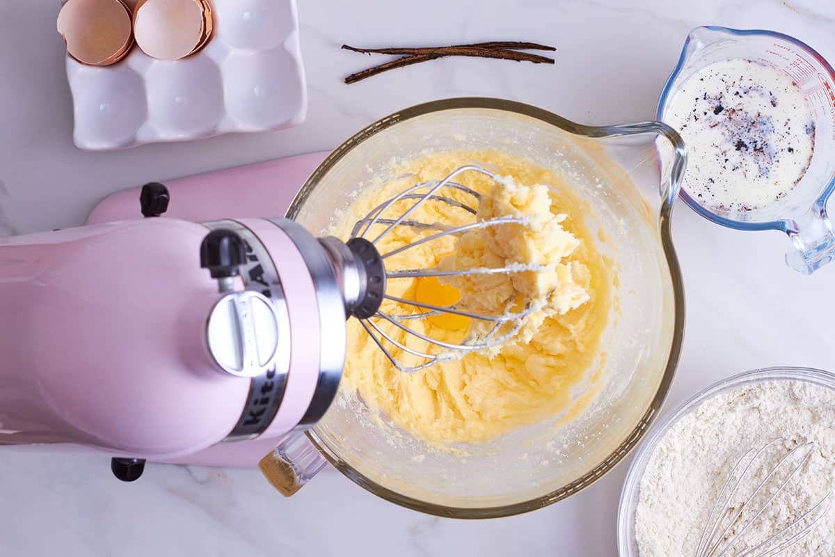 pink kitchen aid with glass bowl filled with creamed butter and sugar